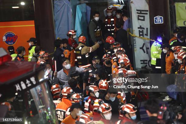 Emergency services treat injured people after a stampede on October 30, 2022 in Seoul, South Korea. At least 50 people were reported to be receiving...