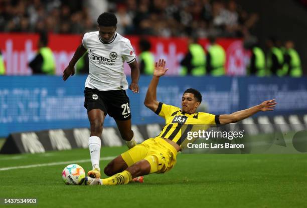 Junior Dina Ebimbe of Eintracht Frankfurt is challenged by Jude Bellingham of Borussia Dortmund during the Bundesliga match between Eintracht...