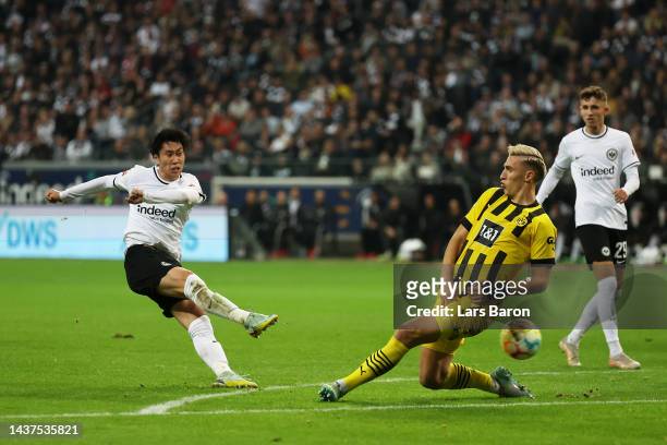 Daichi Kamada of Eintracht Frankfurt scores their side's first goal during the Bundesliga match between Eintracht Frankfurt and Borussia Dortmund at...