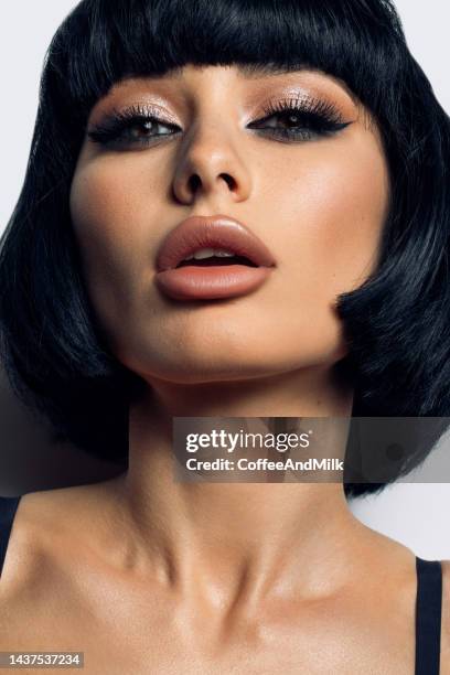 beautiful woman with bright make-up - black hair wig stock pictures, royalty-free photos & images