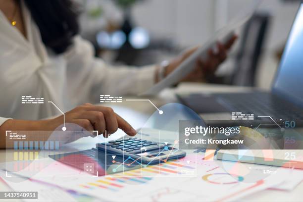 woman working on calculator to calculate business data. accountancy document, finance accounting concept. - audit stockfoto's en -beelden