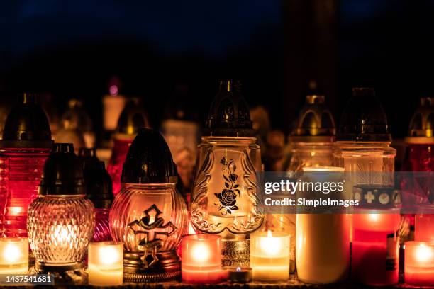 many burning candles in the cemetery at night on the occasion souls of the deceased. - cemetery background stock pictures, royalty-free photos & images