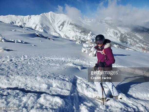 expert mature woman skier. beautiful powder day, snowmass ski resort, aspen, colorado. - ski pants stockfoto's en -beelden