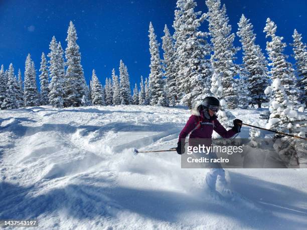expert mature woman skier. beautiful powder day, snowmass ski resort, aspen, colorado. - powder snow stock pictures, royalty-free photos & images
