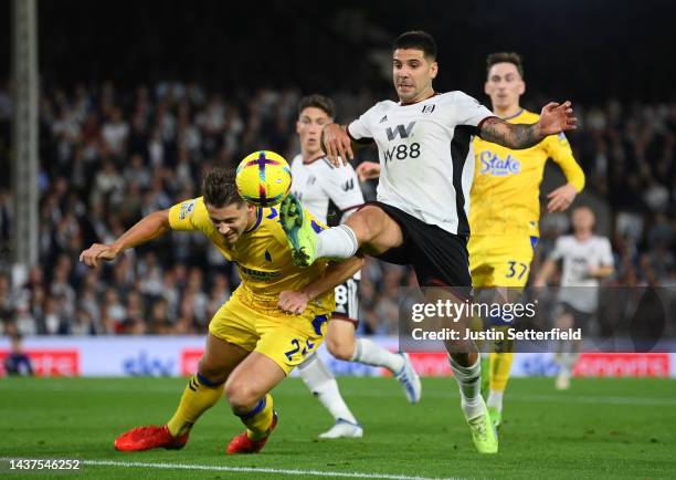 Aleksandar Mitrovic of Fulham is challenged by James Tarkowski of Everton during the Premier League match between Fulham FC and Everton FC at Craven...