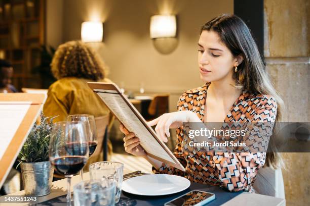 women reading a menu in a restaurant - ordering food stock pictures, royalty-free photos & images