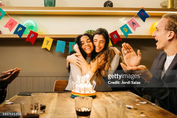group of multiracial young people in a birthday party - birthday stock-fotos und bilder