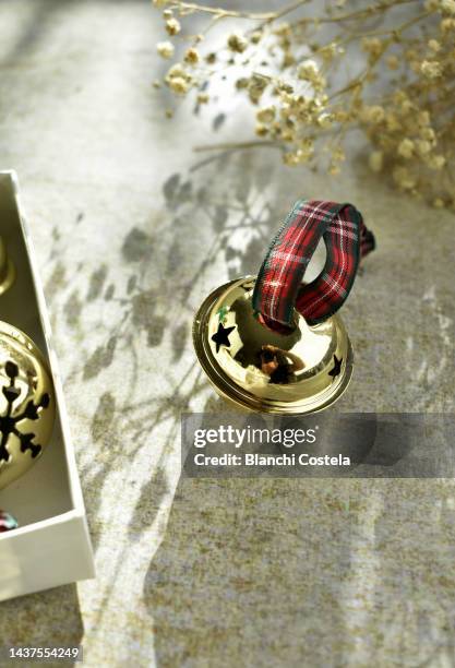 christmas decoration in the form of golden jingle bells - hand bell stock pictures, royalty-free photos & images