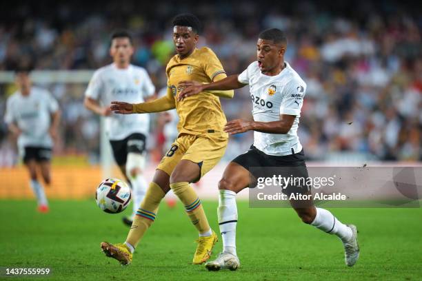 Alejandro Balde of FC Barcelona battles for possession with Samuel Lino of Valencia CF during the LaLiga Santander match between Valencia CF and FC...