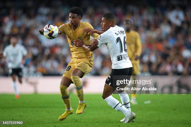 Alejandro Balde of FC Barcelona battles for possession with Samuel Lino of Valencia CF during the LaLiga Santander match between Valencia CF and FC...