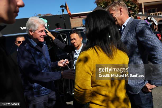Former President Bill Clinton greets Daley Florke and Randy Florke, the daughter and husband of Rep. Sean Patrick Maloney during a rally at Nyack...