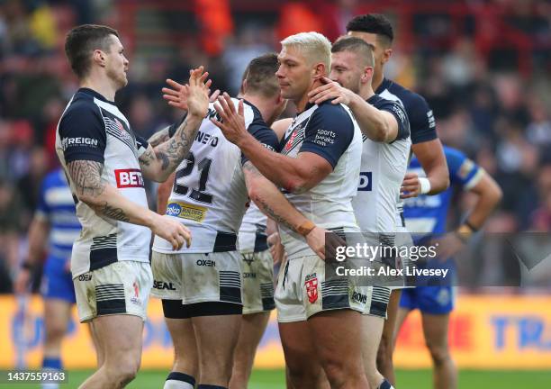 Ryan Hall and John Bateman of England celebrate with Andy Ackers after he scored their sides sixteenth try during Rugby League World Cup 2021 Pool A...