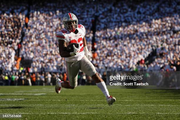 TreVeyon Henderson of the Ohio State Buckeyes scores a touchdown against the Penn State Nittany Lions during the second half at Beaver Stadium on...