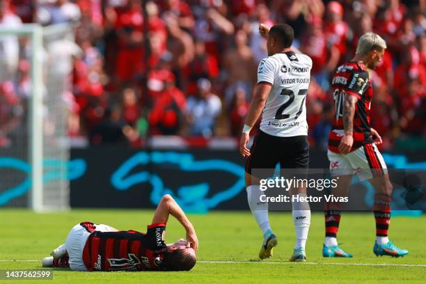 Filipe Luís of Flamengo reacts after suffering an injury during the final of Copa CONMEBOL Libertadores 2022 between Flamengo and Athletico...