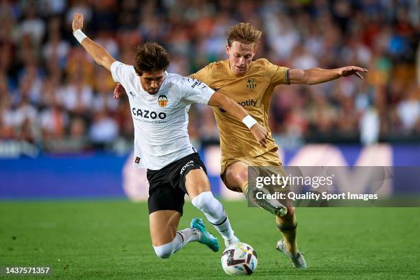 Jesus Vazquez of Valencia CF competes for the ball with Frenkie De Jong of FC Barcelona during the LaLiga Santander match between Valencia CF and FC...