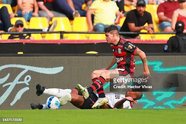 Ayrton Lucas of Flamengo falls down over Fernandinho of Athletico-PR during the final of Copa CONMEBOL Libertadores 2022 between Flamengo and...