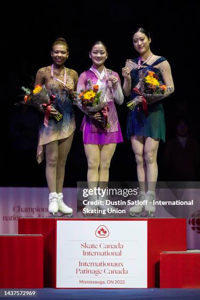 Starr Andrews of the United States, Rinka Watanabe of Japan, and Young You of South Korea on the podium after the women's free skate during the ISU...