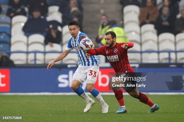 Yuta Nakayama of Huddersfield Town battles with Mason Bennett of Millwall during the Sky Bet Championship game between Huddersfield Town and Millwall...