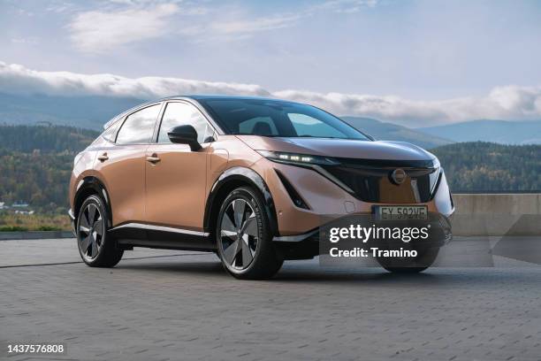 nissan ariya on a parking - nissan-ariya stock pictures, royalty-free photos & images