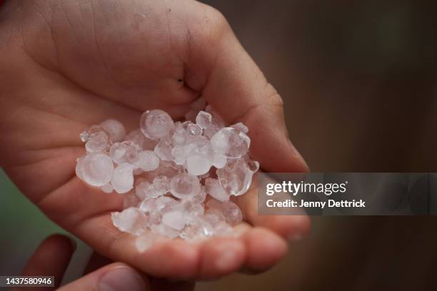 boy's hand holding hailstones - hail foto e immagini stock