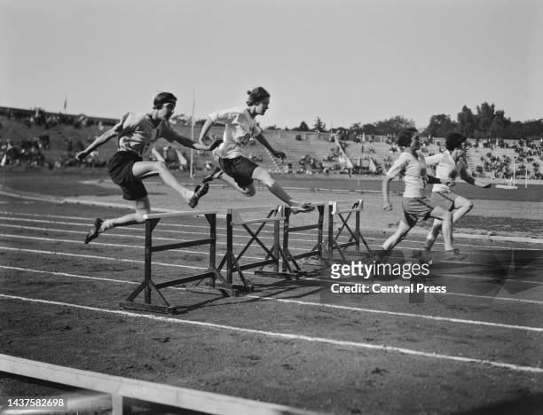 Competitors in the 100 yards hurdles event at the 1922 Women's World Games at the Pershing Stadium in Paris, 20th August 1922. Left to right:...