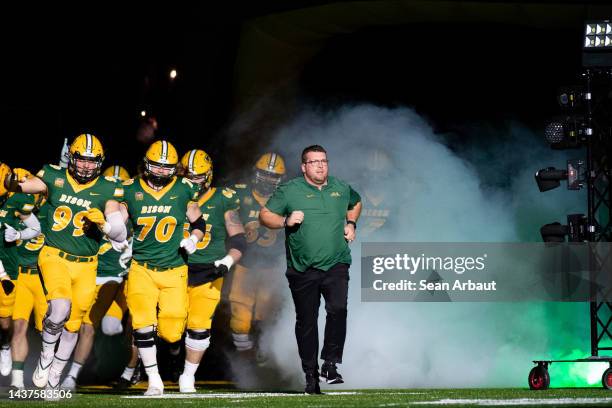 Head coach Matt Entz of the North Dakota State Bison runs out of the tunnel with his players before the game against the Illinois State Redbirds at...
