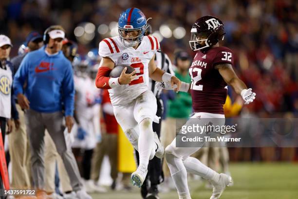 Jaxson Dart of the Mississippi Rebels runs the ball while defended by Andre White Jr. #32 of the Texas A&M Aggies in the first half of the game at...