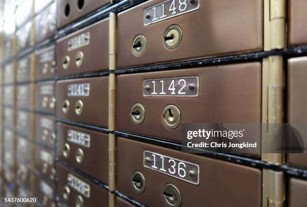 bank of safety deposit boxes - bankschließfach stock-fotos und bilder