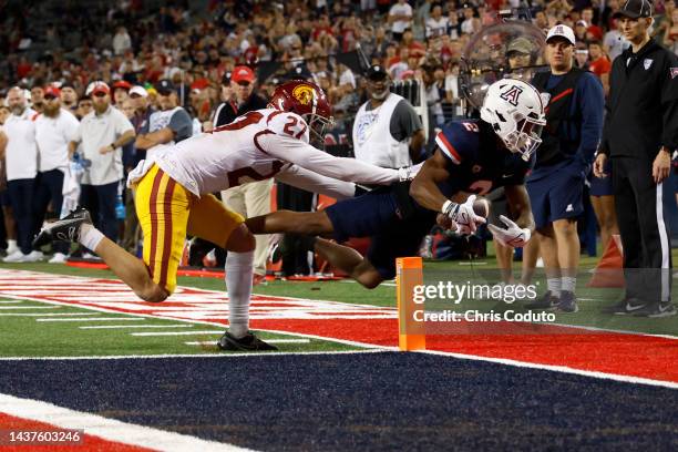 Wide receiver Jacob Cowing of the Arizona Wildcats scores on a two point conversion attempt while being tackled by defensive back Bryson Shaw of the...