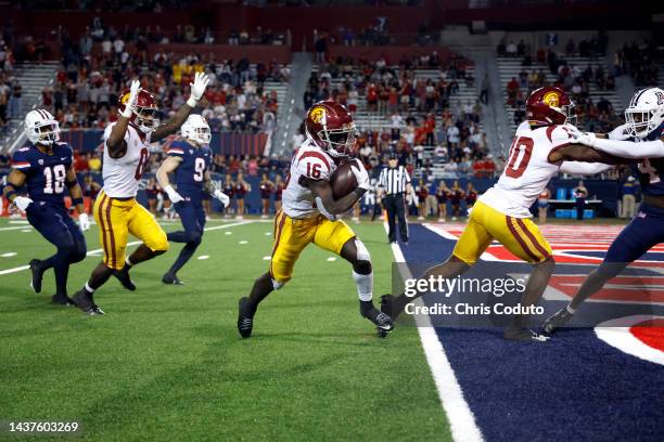 Wide receiver Tahj Washington of the USC Trojans scores a touchdown during the second half against the Arizona Wildcats at Arizona Stadium on October...