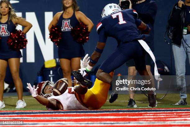 Wide receiver Brenden Rice of the USC Trojans can't hang on to a pass while being defended by cornerback Ephesians Prysock of the Arizona Wildcats...
