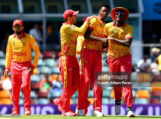 Blessing Muzarabani of Zimbabwe celebrates with team mates after dismissing Litton Das of Bangladesh during the ICC Men's T20 World Cup match between...