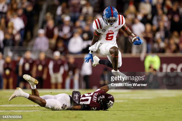 Zach Evans of the Mississippi Rebels hurdles Jardin Gilbert of the Texas A&M Aggies in the second half of the game at Kyle Field on October 29, 2022...
