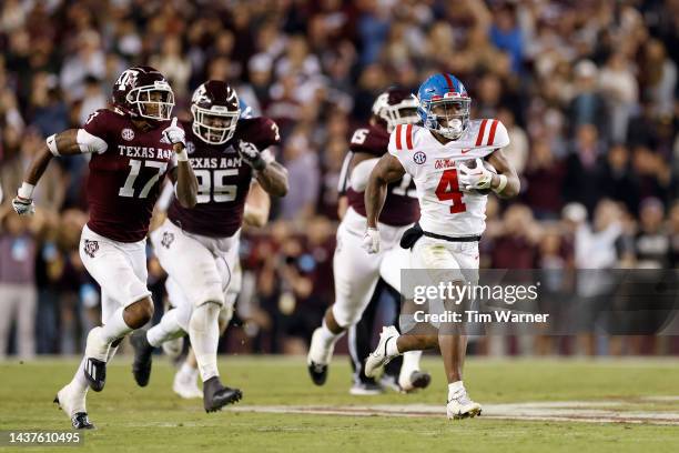 Quinshon Judkins of the Mississippi Rebels rushes the ball pursued by Jaylon Jones of the Texas A&M Aggies in the second half of the game at Kyle...