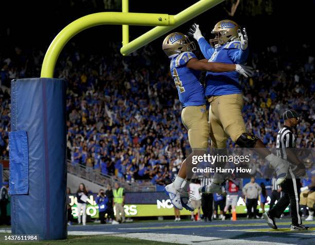 Zach Charbonnet of the UCLA Bruins celebrates his touchdown with Raiqwon O'Neal, to take a 14-3 lead over the Stanford Cardinal, during the first...