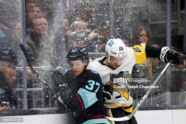 Yanni Gourde of the Seattle Kraken and Jeff Petry of the Pittsburgh Penguins collide during the second period of the game at Climate Pledge Arena on...