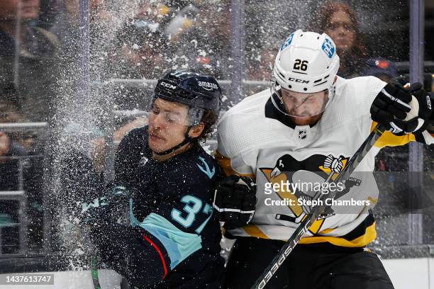 Yanni Gourde of the Seattle Kraken and Jeff Petry of the Pittsburgh Penguins collide during the second period of the game at Climate Pledge Arena on...