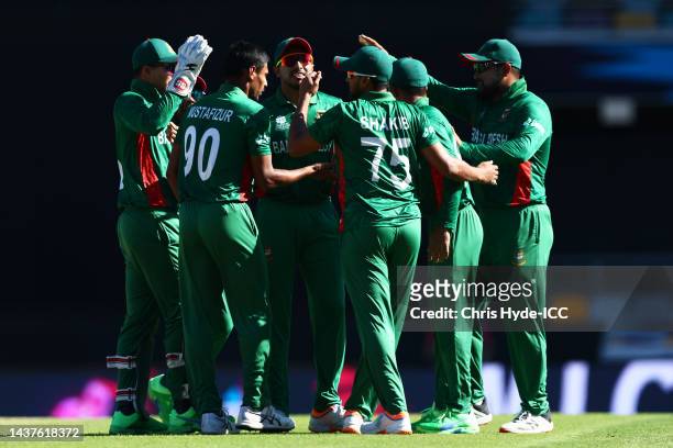 Mustafizur Rahman of Bangladesh celebrates with team mates after taking the wicket of Sikandar Raza of Zimbabwe during the ICC Men's T20 World Cup...