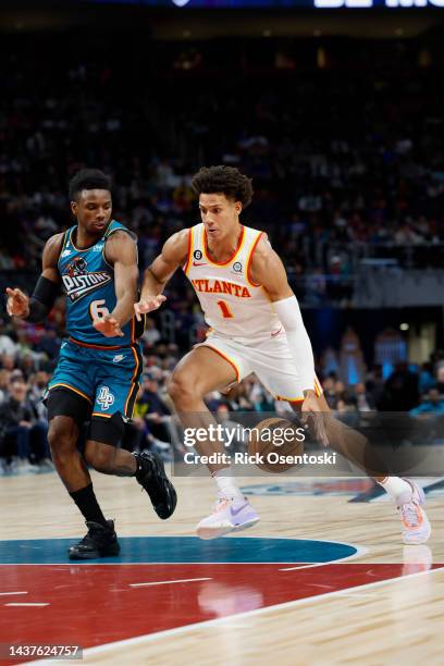 Jalen Johnson of the Atlanta Hawks dribbles on Hamidou Diallo of the Detroit Pistons at Little Caesars Arena on October 28, 2022 in Detroit,...