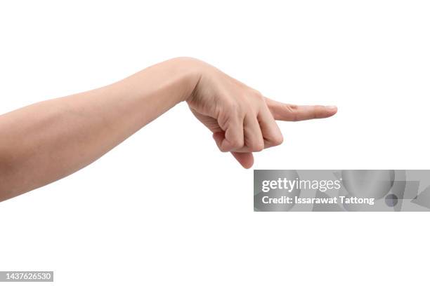 aggressive woman pointing finger blaming you standing posing expressing negative emotions over white studio background. - wijzen handgebaar stockfoto's en -beelden