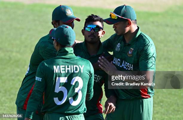 Musaddek Hossain of Bangladesh and team mates celebrate victory after the ICC Men's T20 World Cup match between Bangladesh and Zimbabwe at The Gabba...