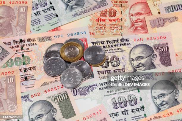 indian rupee notes and coins, close up - gandhi stock-fotos und bilder