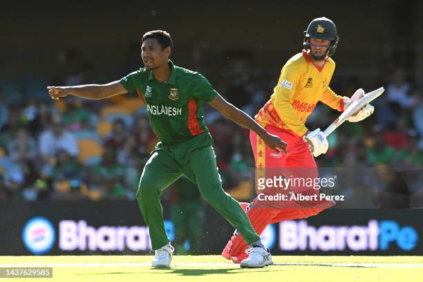 Mustafizur Rahman of Bangladesh gestures as Sean Williams of Zimbabwe runs between the wickets during the ICC Men's T20 World Cup match between...