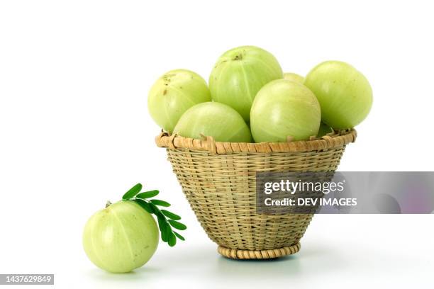 basket of gooseberries against white background - uva spina foto e immagini stock