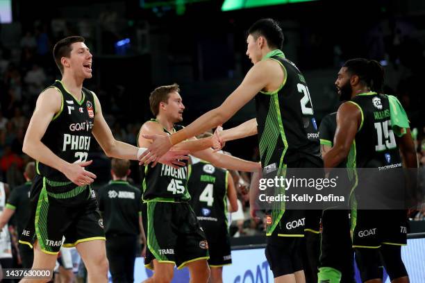 Dane Pineau of the Phoenix and Zhou Qi of the Phoenix celebrates victory with team mates during overtime in the round five NBL match between South...