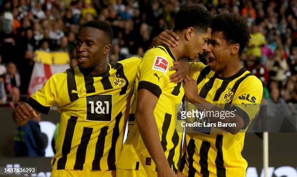Jude Bellingham of Dortmund celebrates with Youssoufa Moukoko of Dortmund and Karim Adeyemi of Dortmund after scoring his teams second goal during...