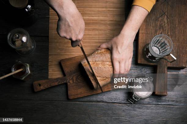 drinking hot tea with apple marmalade toast - bread knife stockfoto's en -beelden