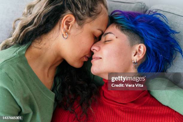 close up of lesbian couple in love with valentine winter clothes - lesbian date stock-fotos und bilder