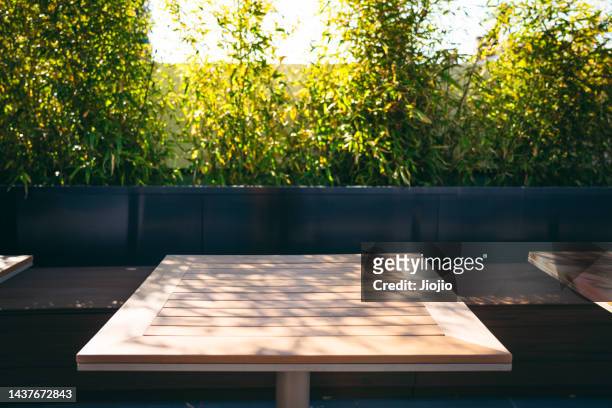 wooden table - cafe table chair outside ストックフォトと画像