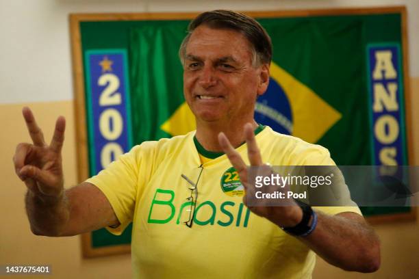 Incumbent Jair Bolsonaro of Liberal Party , who is running for another term, greets the press after casting his vote at Vila Militar district on...